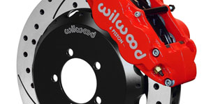 a close up shot of a brake rotor with a red calliper